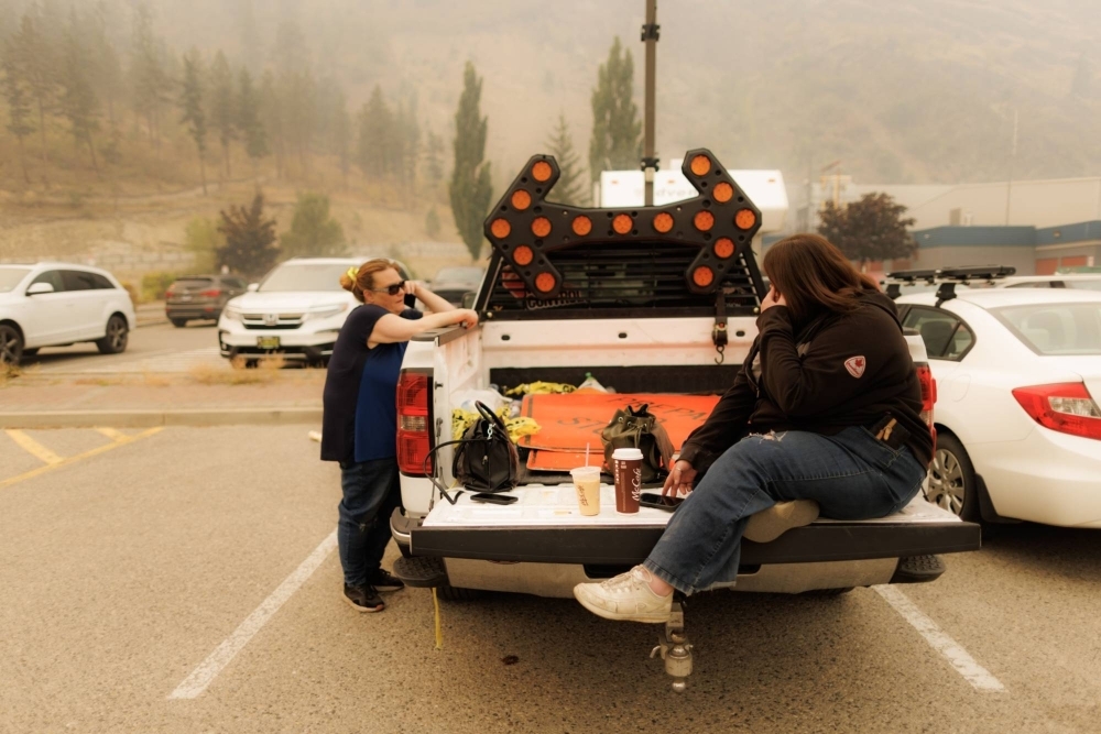 Evacuees wait outside an evacuation center during a wildfire in West Kelowna, British Columbia, Canada, last Sunday.