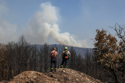 Czech firefighters watch smoke rising as a wildfire burns at the Dadia National Park in the region of Evros, Greece, on Tuesday.