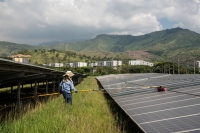 A worker cleans solar panels at a solar farm facility in Yumbo, Colombia. | Bloomberg
