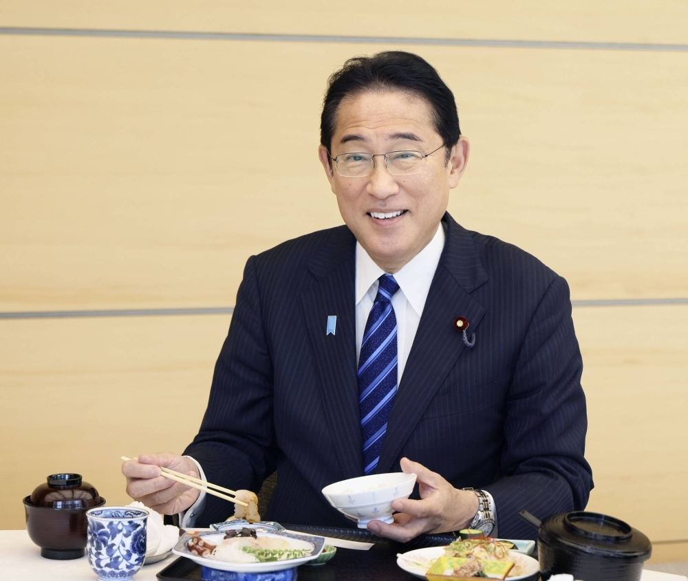 Prime Minister Fumio Kishida eats fish from Fukushima Prefecture at a luncheon on Wednesday.
