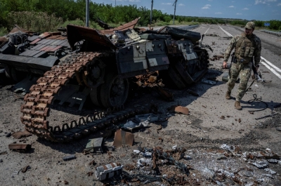 A Ukrainian serviceman walks near a destroyed Ukrainian tank, as Russia's attack on Ukraine continues, near the village of Robotyne, Zaporizhzhia region, Ukraine, on Friday.