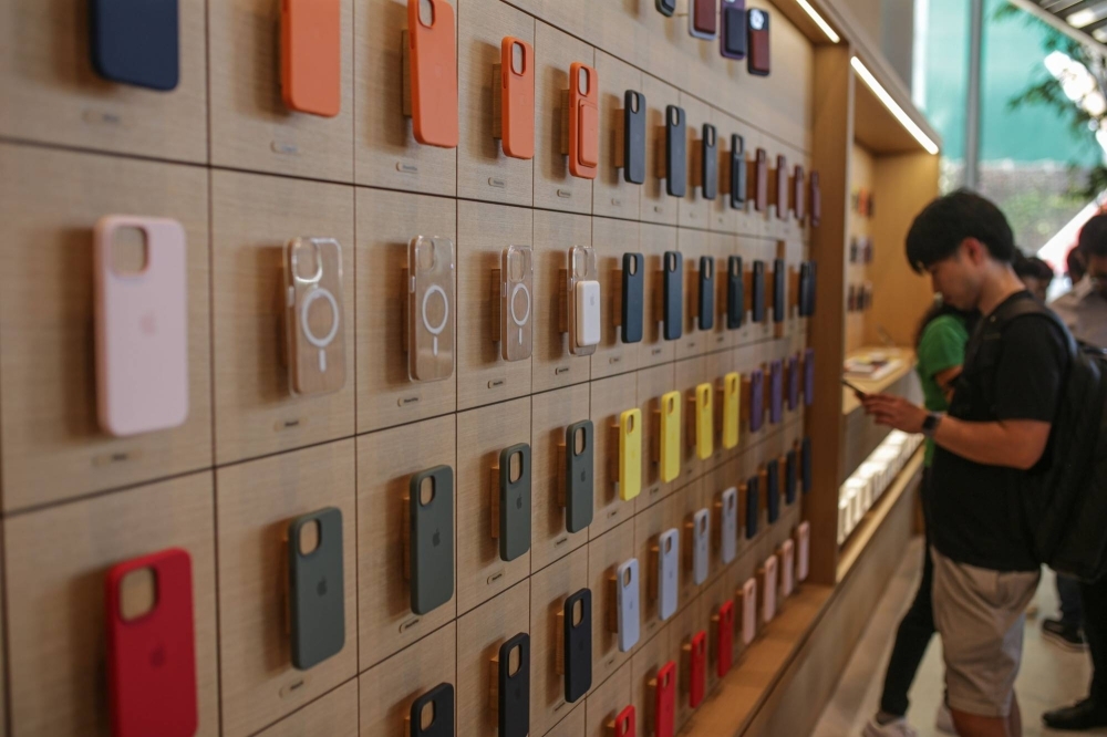 A customer browses iPhone cases at an Apple store in India.