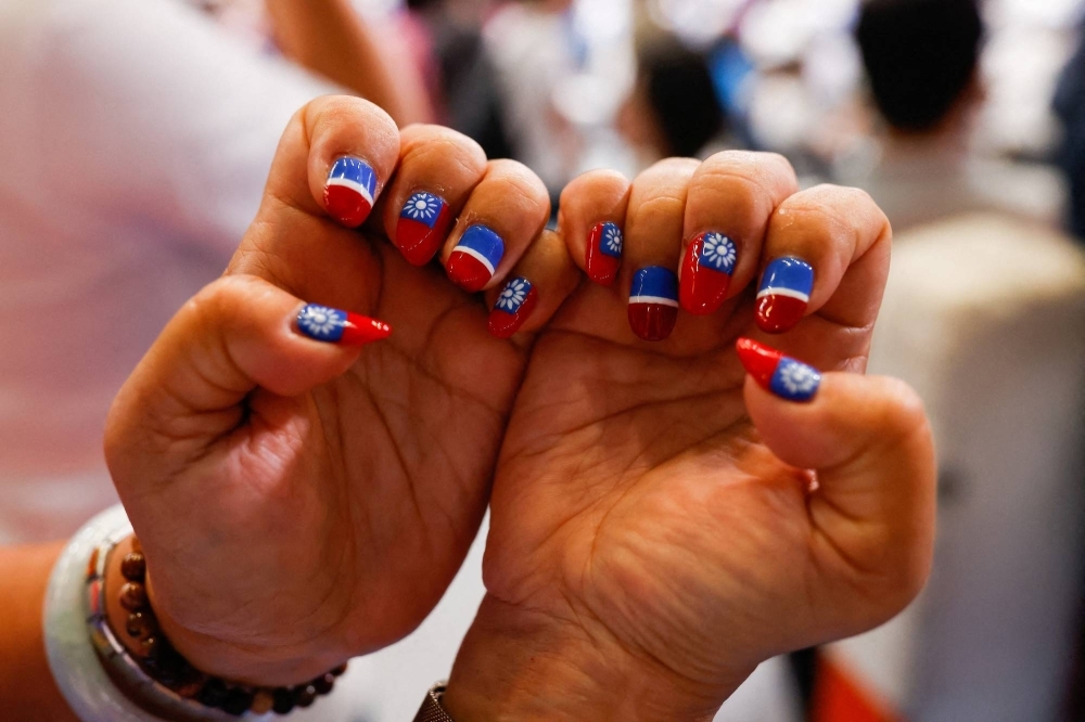 A supporter of the main opposition Kuomintang party shows their fingernails painted with the Taiwan flag, during the party's annual conference in New Taipei City, Taiwan, on July 23.