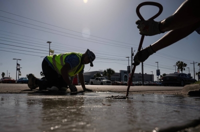 Construction workers repair a street during a heat wave in Corpus Christi, Texas, in July. 