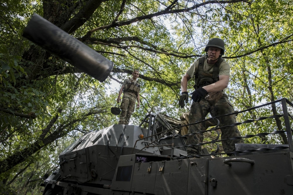 Ukrainian soldiers with the 110th Separate Mechanized Brigade after firing a DANA, a wheeled 152 mm self-propelled artillery gun, at a Russian target in the Donetsk region of eastern Ukraine, on Aug. 26.