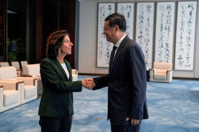 U.S. Commerce Secretary Gina Raimondo is greeted by Shanghai Party Secretary Chen Jining, in Shanghai on Wednesday.