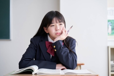 A Japanese junior high school student stares off into space while in the classroom. If your child is distracted or preoccupied during lessons, it may be time to speak with their teacher.