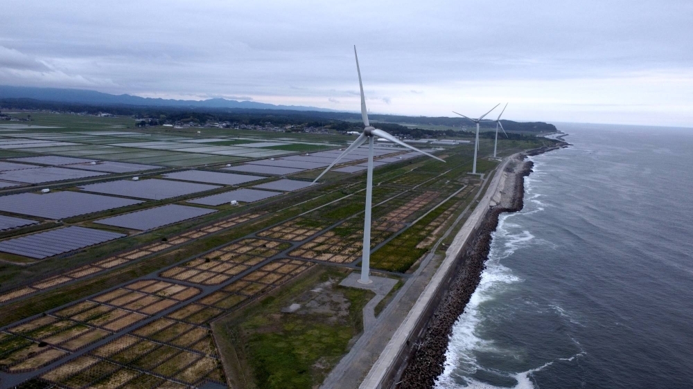 Nestled behind a seawall on the Pacific coast are the Minamisoma Mano-Migita-Ebi solar power plant and the Manyo no Sato wind farm. The 2011 tsunami struck this portion of the coast with a wave that is reported to have been around 18 meters high.