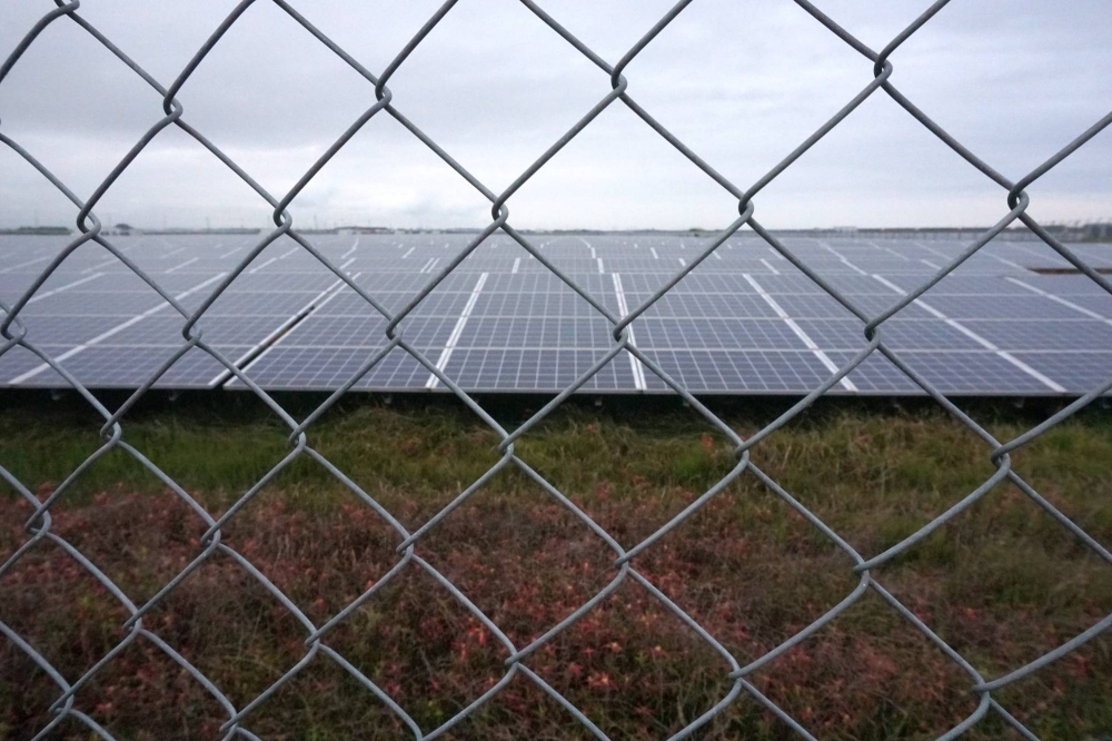 Metal fences and barbed wire surround the Minamisoma Mano-Migita-Ebi solar power plant.