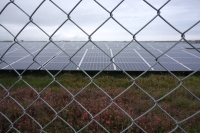 Metal fences and barbed wire surround the Minamisoma Mano-Migita-Ebi solar power plant. | Francesco Bassetti

