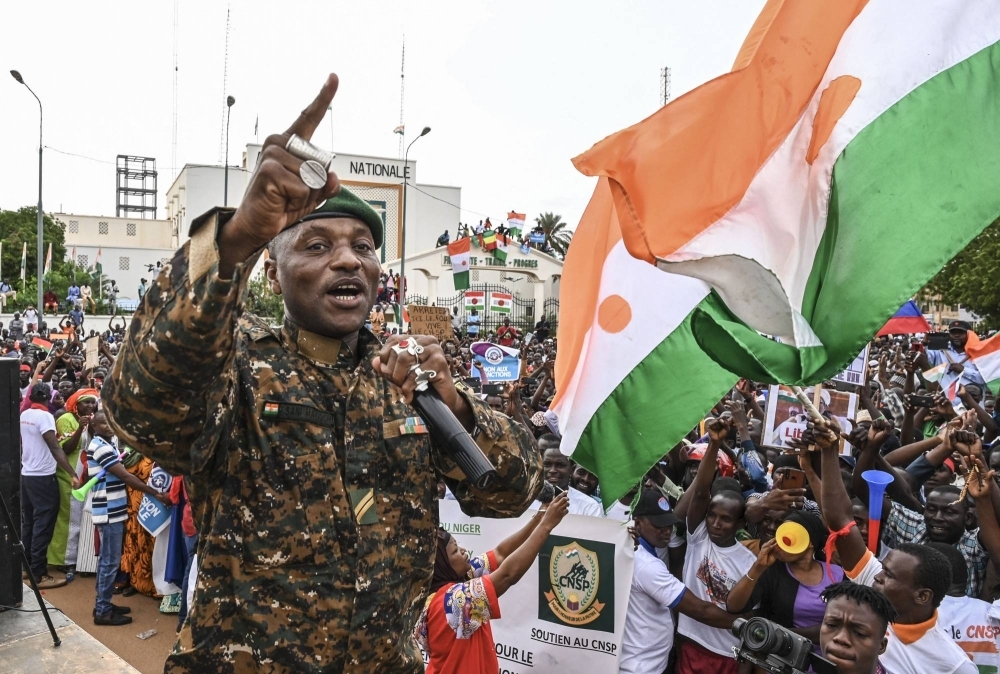 Niger's Army sergeant and artist Maman Sani Maigochi performs as supporters of Niger's National Council of Safeguard of the Homeland gather at Place de la Concertation in Niamey.
