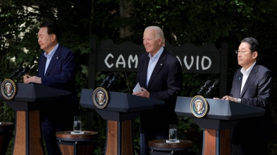South Korean President Yoon Suk-yeol (left), U.S. President Joe Biden (center) and Prime Minister Fumio Kishida hold a joint news conference following a trilateral summit at Camp David near Thurmont, Maryland, on Aug. 18.