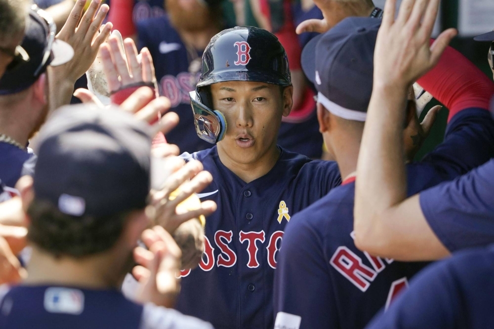 The Red Sox's Masataka Yoshida returns to the dugout after hitting a three-run home run against the Royals in Kansas City, Missouri, on Sunday.