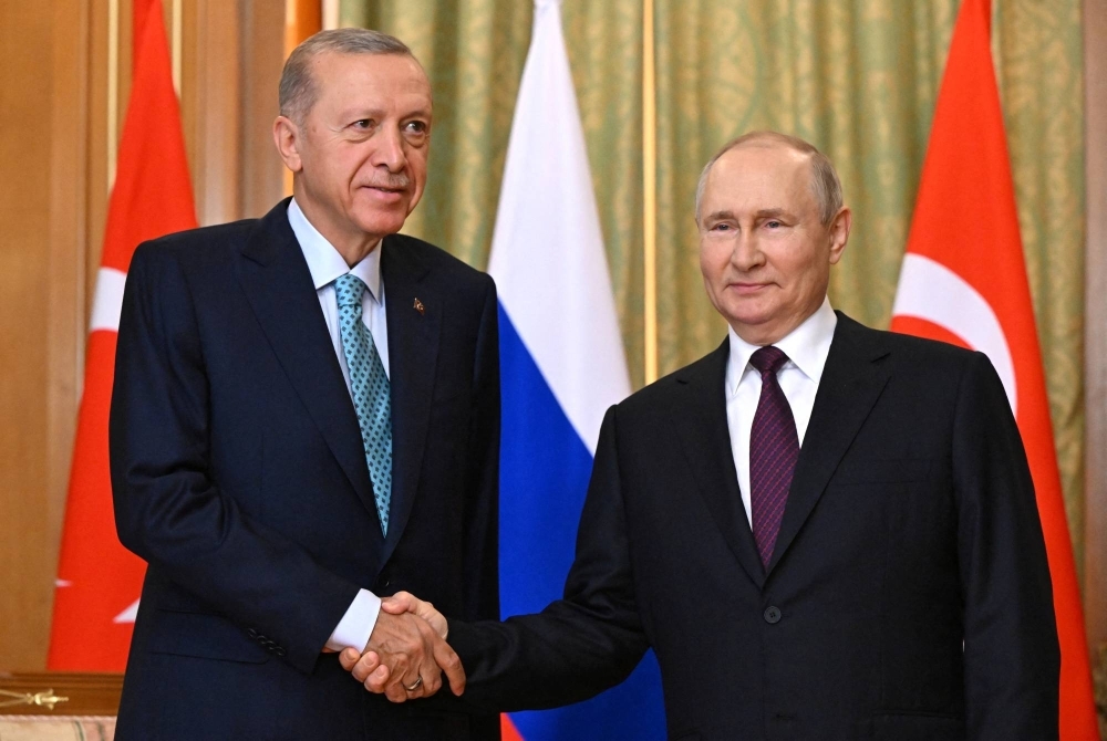 Russian President Vladimir Putin shakes hands with Turkish President Tayyip Erdogan during a meeting in Sochi, Russia, on Monday.
