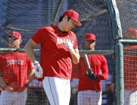 Shohei Ohtani of the Los Angeles Angels seemingly winces in pain after taking a check-swing during batting practice on Monday at Angel Stadium in Anaheim, California. | Kyodo