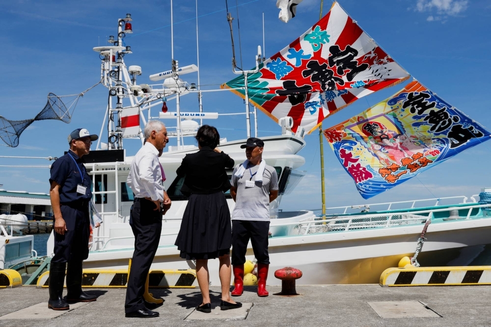 U.S. Ambassador to Japan Rahm Emanuel talks to local fishermen on Thursday to show his support for the water discharge from the nearby Fukushima No. 1 nuclear power plant.