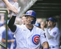 Seiya Suzuki of the Chicago Cubs celebrates after a home run in the second inning of a game against the San Francisco Giants at Wrigley Field on Monday in Chicago. | Getty / Via Kyodo