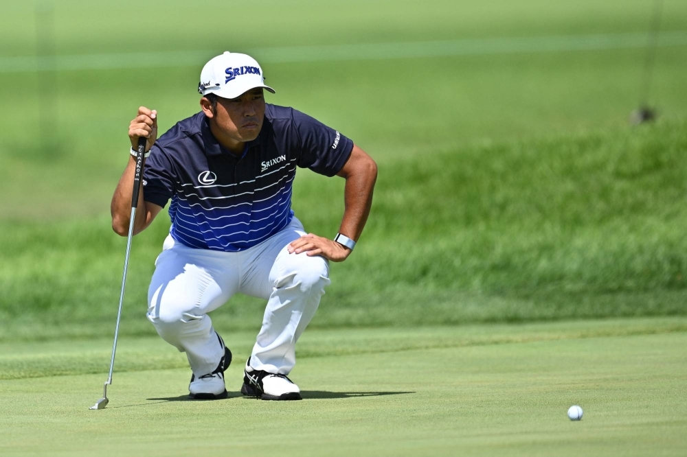 Hideki Matsuyama lines up a putt during the first round of the BMW Championship golf tournament in Olympia Fields, Illinois, on Aug. 17.