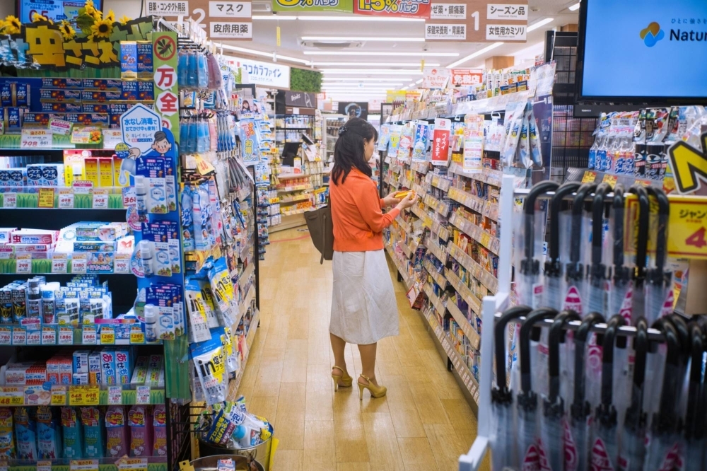 A woman shops for medicine at a drugstore in Tokyo.