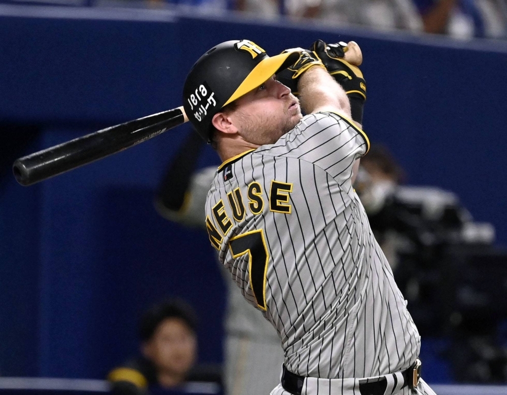 Sheldon Neuse of the Hanshin Tigers doubles in a run against the Chunichi Dragons in their Central League game at Vantelin Dome Nagoya on Tuesday.