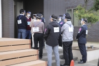 Officers of Chiba Prefectural Police department and child consultation center workers use a model house to conduct joint training in the city of Kimitsu in Chiba Prefecture last November. | KYODO
