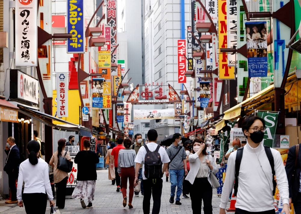 People make their way through Tokyo's Ameyoko shopping district. In a sign rising inflation is already taking a toll on consumption, Japan's household spending suffered its biggest drop in nearly 2½ years in July.