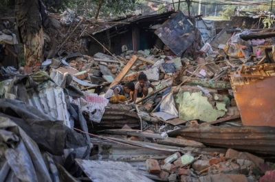 Children try to salvage their belongings from the rubble of their house after a demolition drive by the authorities at a slum area near the upcoming G20 Summit main venue in New Delhi, in June.