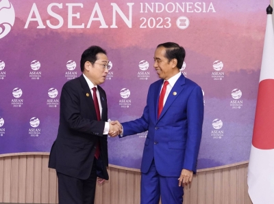 Prime Minister Fumio Kishida (left) shakes hands with Indonesian President Joko Widodo in Jakarta on Thursday.