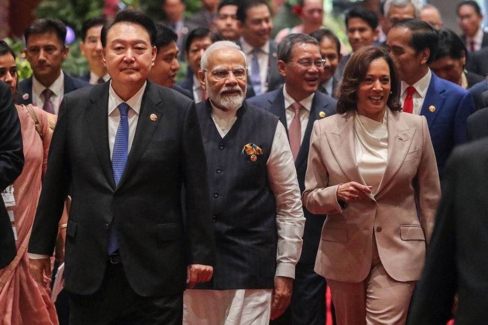 South Korean President Yoon Suk-yeol (left), Indian Prime Minister Narendra Modi (center), Chinese Premier Li Qiang (back, second right), U.S. Vice President Kamala Harris (front right) and Indonesian President Joko Widodo (back right) arrive for the East Asia Summit as part of Association of Southeast Asian Nations meetings in Jakarta on Thursday.