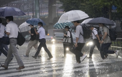 Commuters walk through the rain near Tokyo Station on Friday morning.