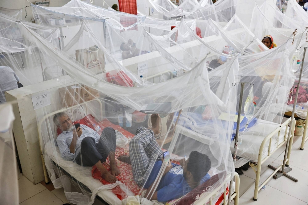 Dengue-infected patients stay under mosquito nets as they receive treatment at the Shaheed Suhrawardy Medical College and Hospital in Dhaka.
