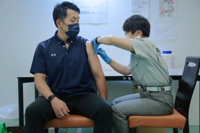 A man receives a COVID-19 vaccination  at Aoyama University in Tokyo in August 2021.  