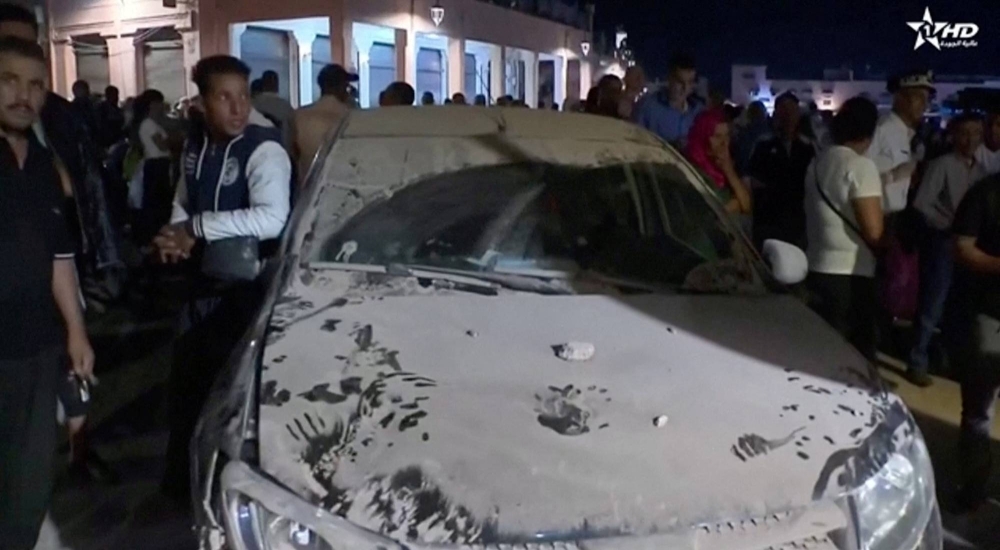 A car is covered in dust in the aftermath of an earthquake in Marrakech, Morocco, on Saturday in this screen shot taken from  video.