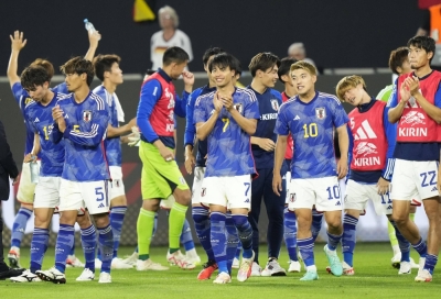 Samurai Blue players celebrate their international friendly win over host Germany in Wolfsburg on Saturday.