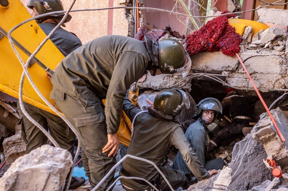 Rescue workers search for survivors in a collapsed house in Moulay Brahim, in the Al Haouz province of Morocco.