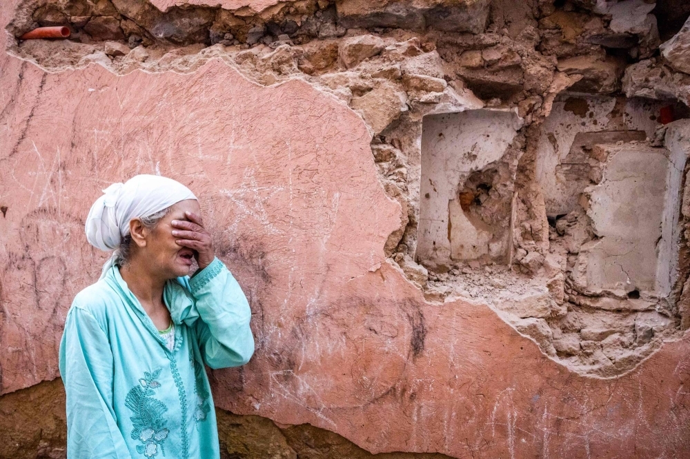 A woman in front of her earthquake-damaged house in the old city in Marrakesh on Saturday