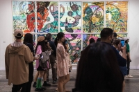 Attendees view "Lizard and Cigarette" by He Xiangyu during Art Basel in Hong Kong in March. | Bloomberg