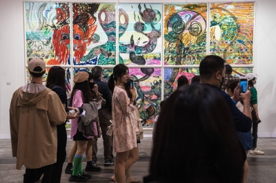 Attendees view "Lizard and Cigarette" by He Xiangyu during Art Basel in Hong Kong in March.