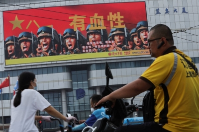 A screen shows an image of Chinese People's Liberation Army soldiers in Beijing in August last year. The PLA's newspaper recently explained to its readers how ChatGPT can be used for military purposes.