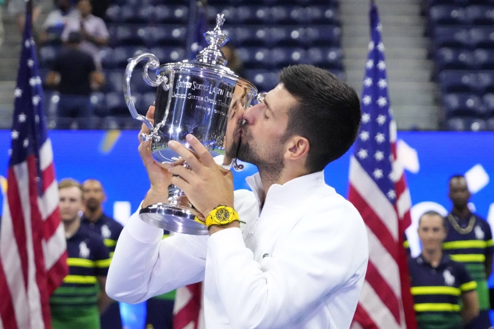 Novak Djokovic kisses the trophy after defeating Daniil Medvedev in the U.S. Open final in New York on Sunday.