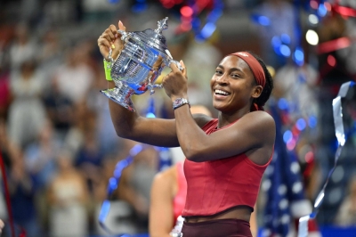 Coco Gauff celebrates with the trophy after winning the U.S. Open to capture her first Grand Slam title on Sunday in New York