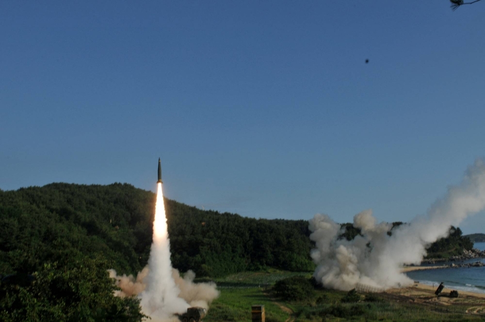 The Army Tactical Missile System (ATACMS) fires missiles into the Sea of Japan off South Korea, in July 2017. The ATACMS under consideration for shipment to Ukraine would propel around 300 or more bomblets.