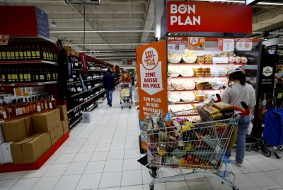 A sign reading "Anti-inflation challenge, second price cut" is seen near shelves at a supermarket in Nice, France, in June.