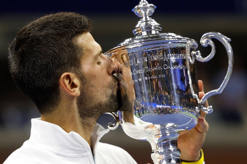 Novak Djokovic kisses the trophy after defeating Daniil Medvedev to win the U.S. Open final in New York on Sunday.