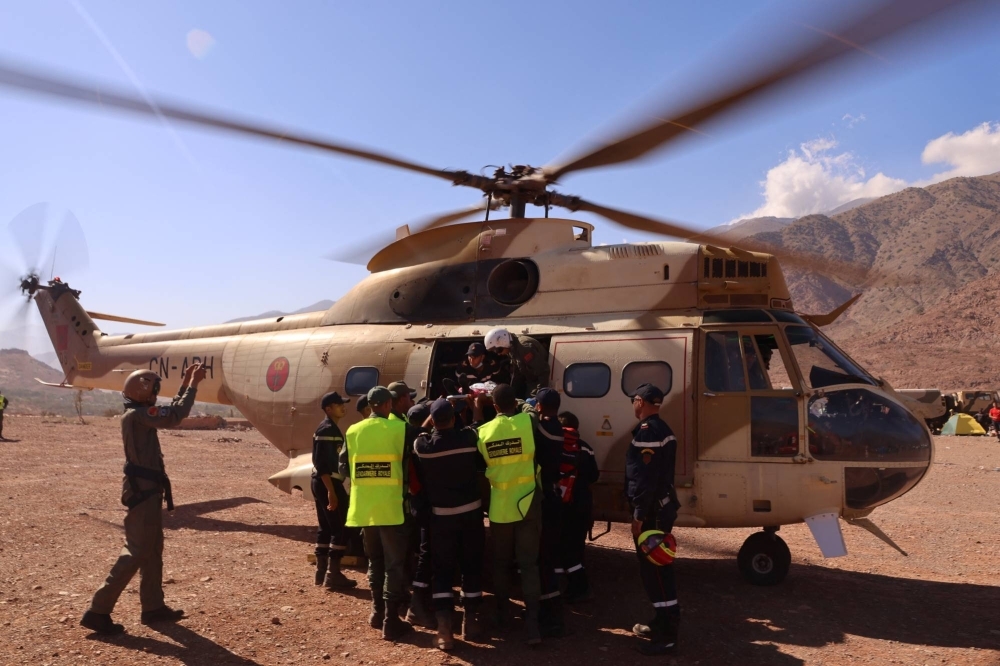 An injured earthquake survivor is carried into a military helicopter to be transported to a hospital after a deadly earthquake in Talat N'Yaaqoub, Morocco, on Tuesday.