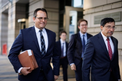 David Dahlquist, senior trial counsel in the antitrust division at the U.S. Department of Justice (left), and Kenneth Dintzer, litigator for the U.S. Department of Justice, leave federal court in Washington on Tuesday.