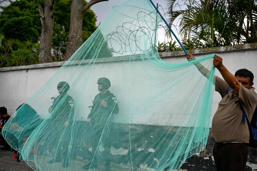 A man sells a mosquito net in Guatemala City.