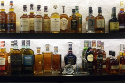 Bottles of whisky sit on display behind the bar at the Door XXV private club in the Golden Equator Group office in Singapore.