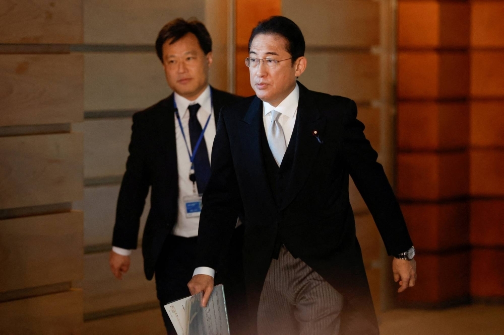 Prime Minister Fumio Kishida leaves his office residence in formal attire to attend an attestation ceremony at the Imperial Palace with his reshuffled Cabinet in Tokyo on Wednesday.