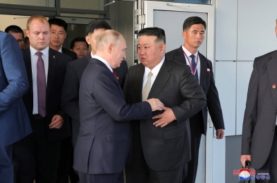 North Korea's leader Kim Jong Un (front right) exchanging farewell greetings with Russia's President Vladimir Putin (front left) at the Vostochny Cosmodrome in Russia's Amur region on Thursday.